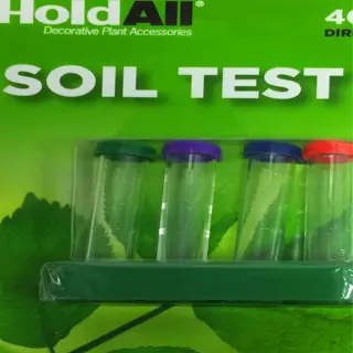 a soil test kit with four vials and colorful caps on a green leafy background
